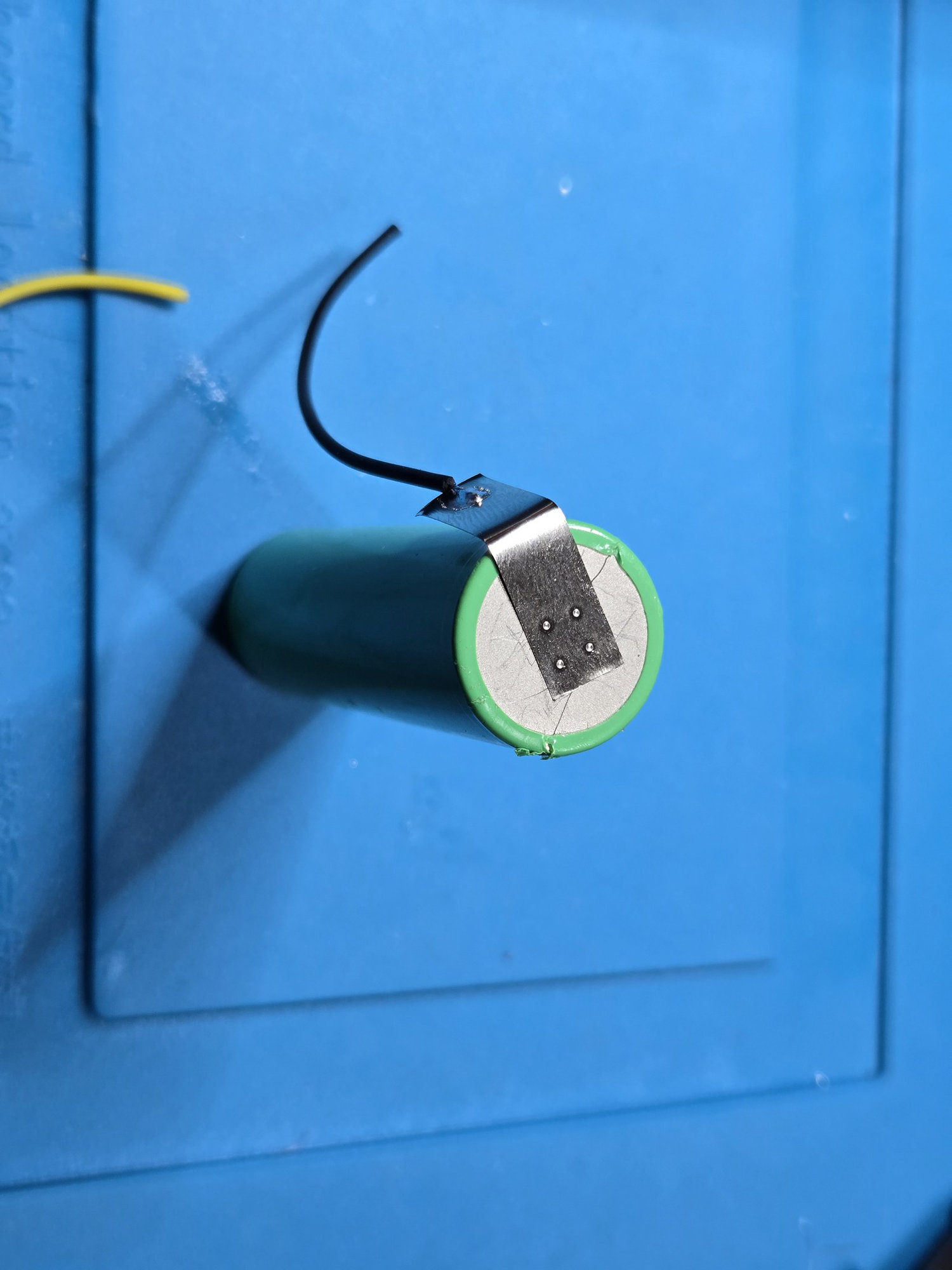 The first nickel tab attached to the cell
