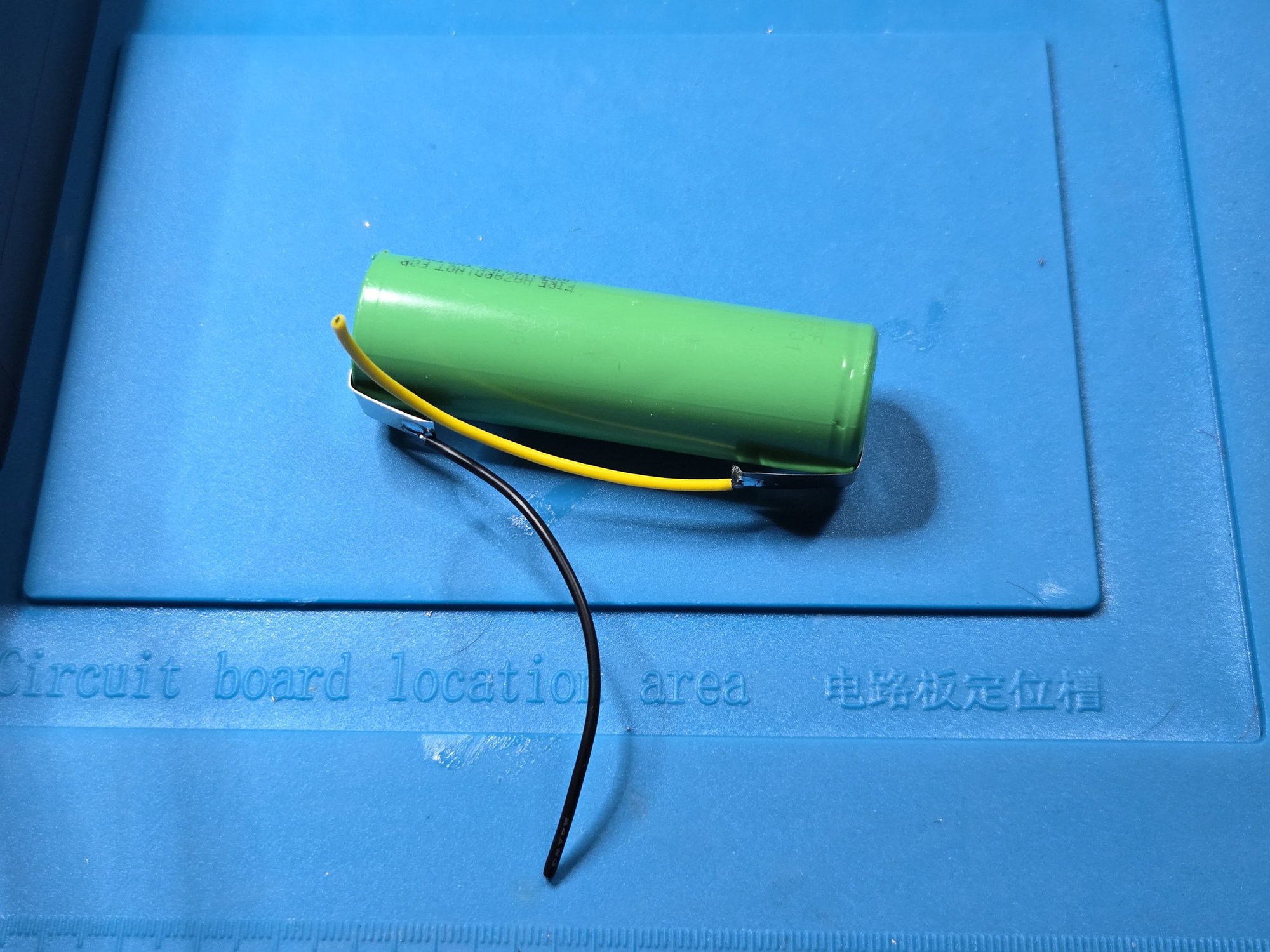 Both nickel tabs fitted and folded along the cell