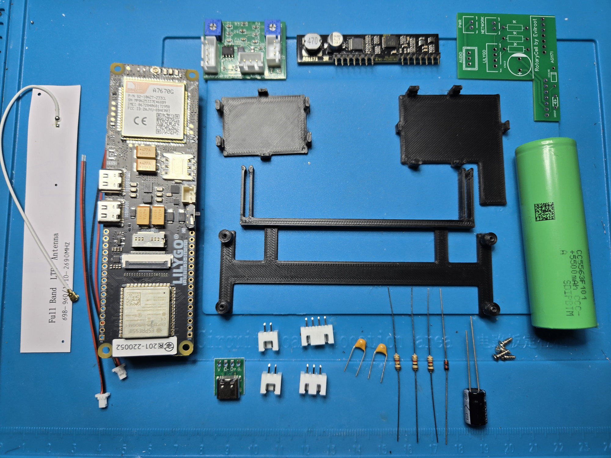RotaryCell electronics and the three black printed mounting parts laid out before assembly