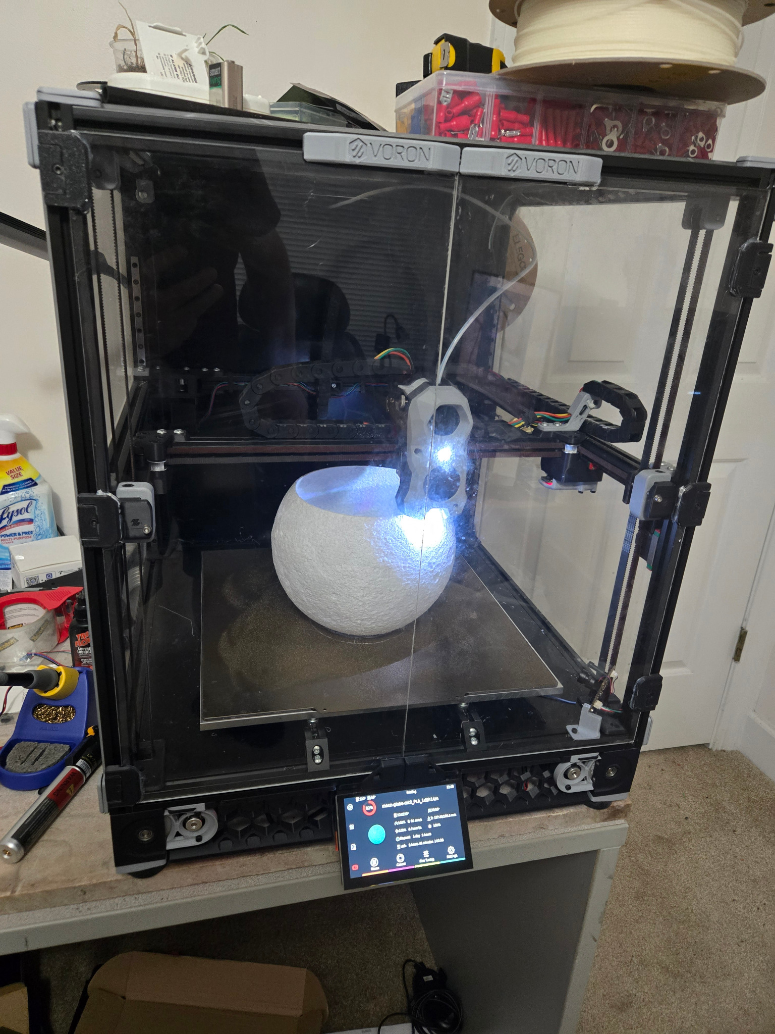 Enclosed Voron 3D printer producing a large curved part