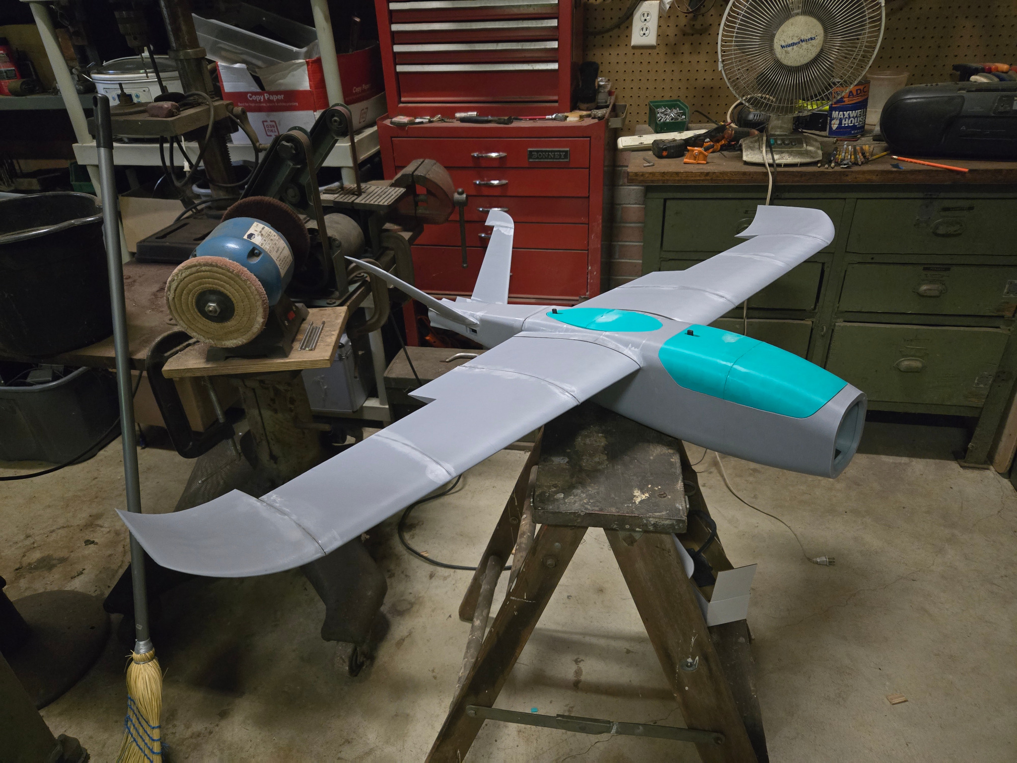 Custom fixed-wing drone under construction in a workshop