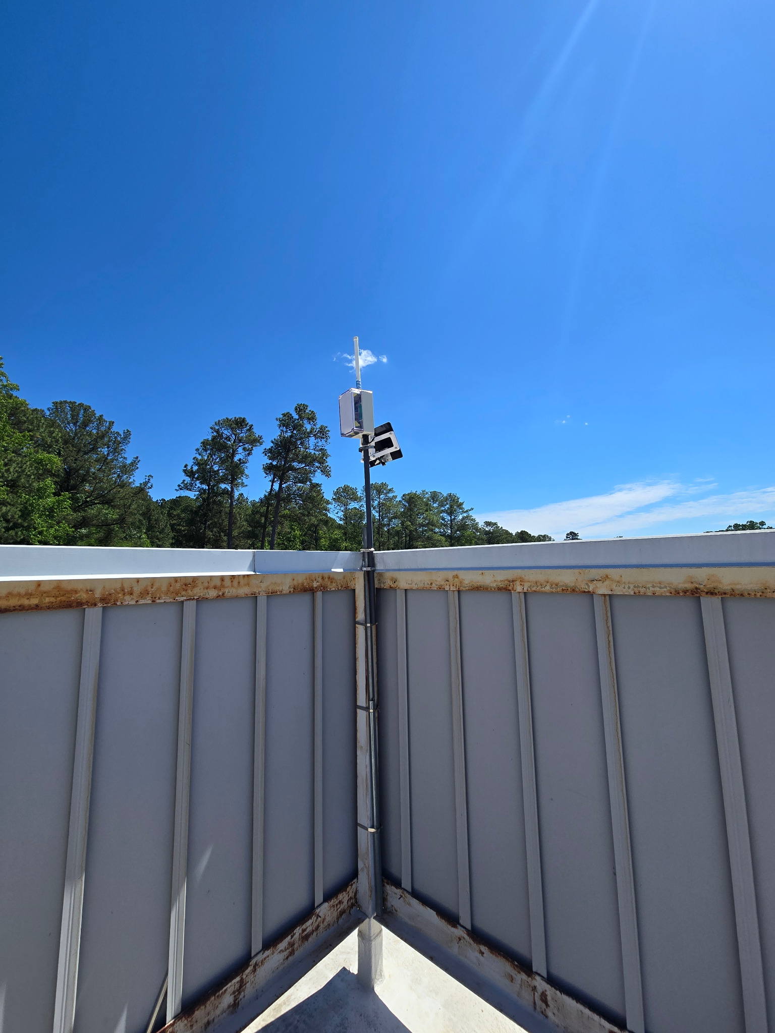 Solar-powered radio repeater installed on a rooftop mast