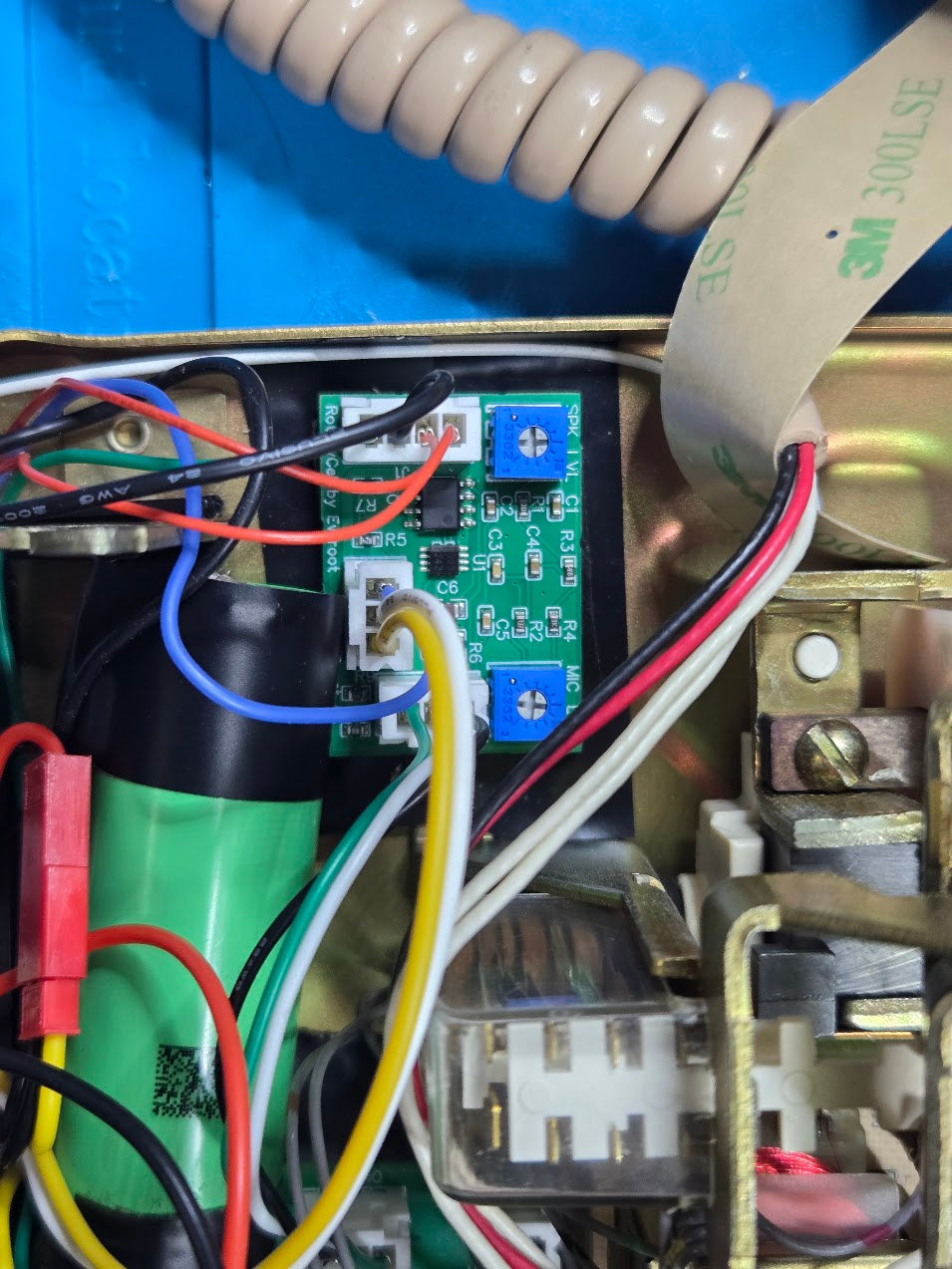 Overhead view of the installed Audio and Reset board showing its two blue level trimmers