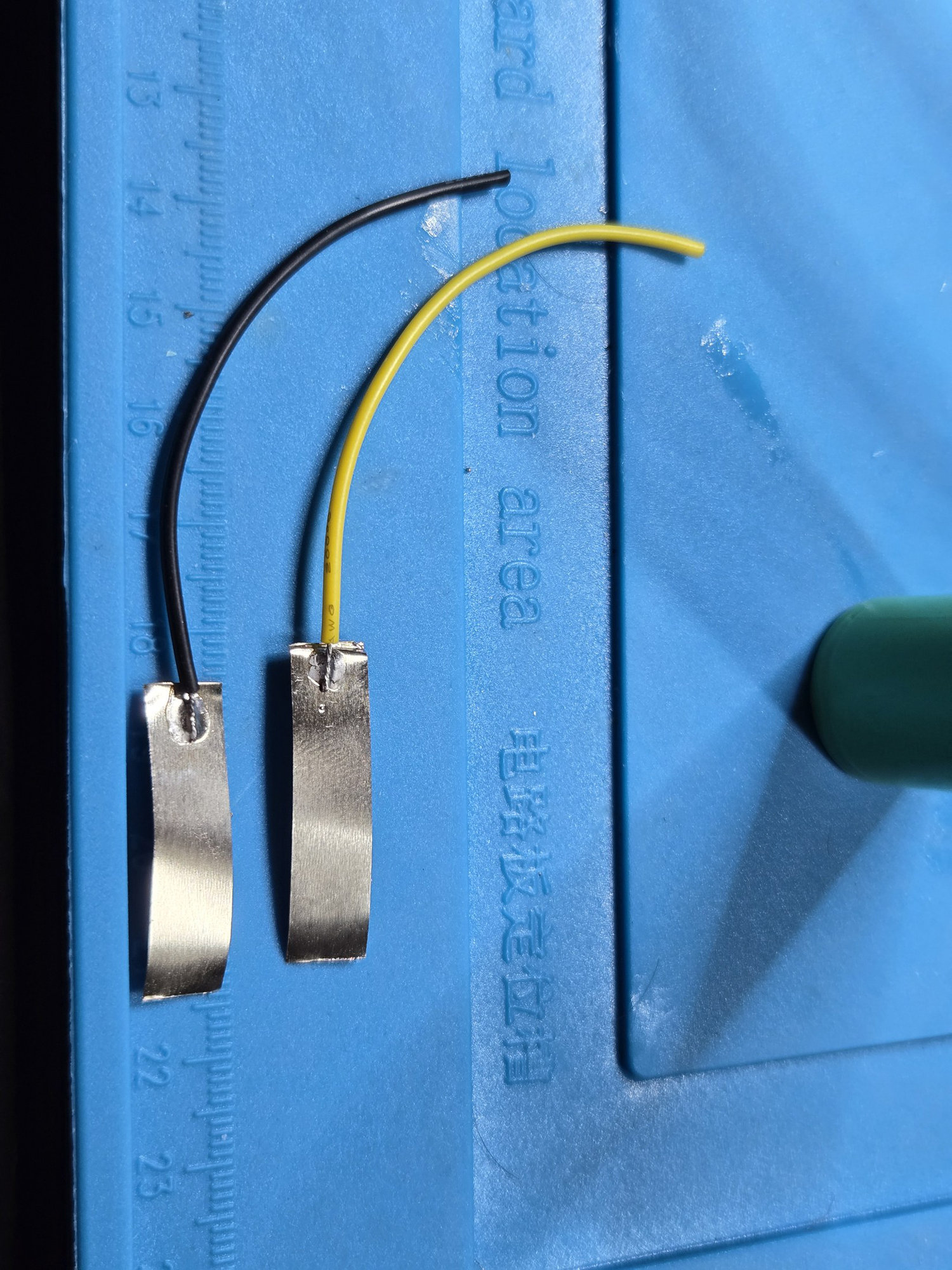 Yellow and black battery leads soldered to nickel tabs