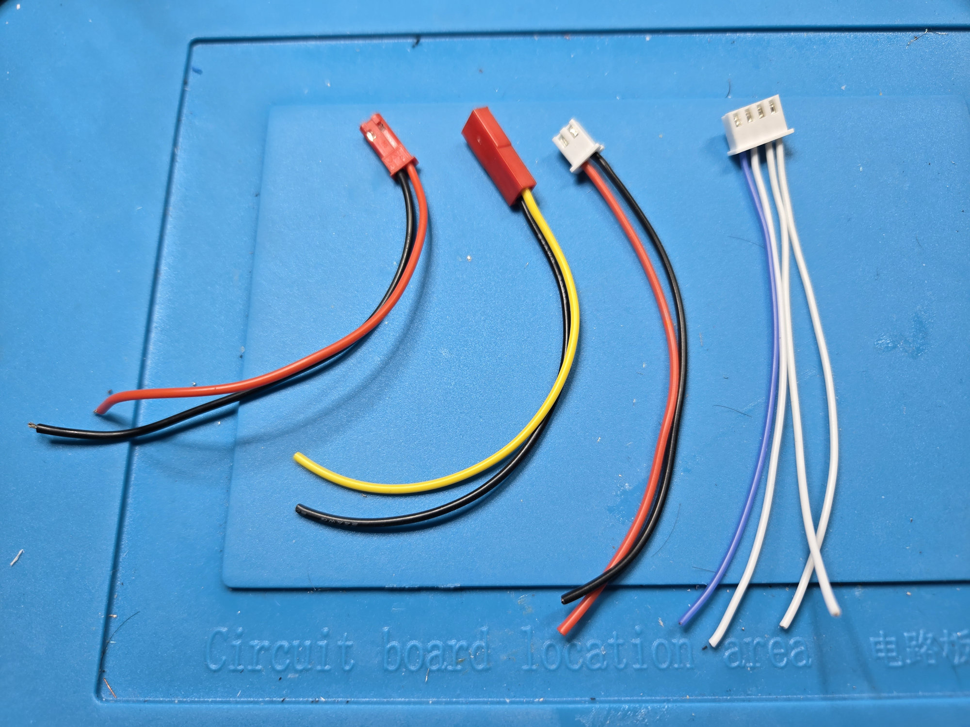 Four prepared LilyGO harnesses laid out before installation