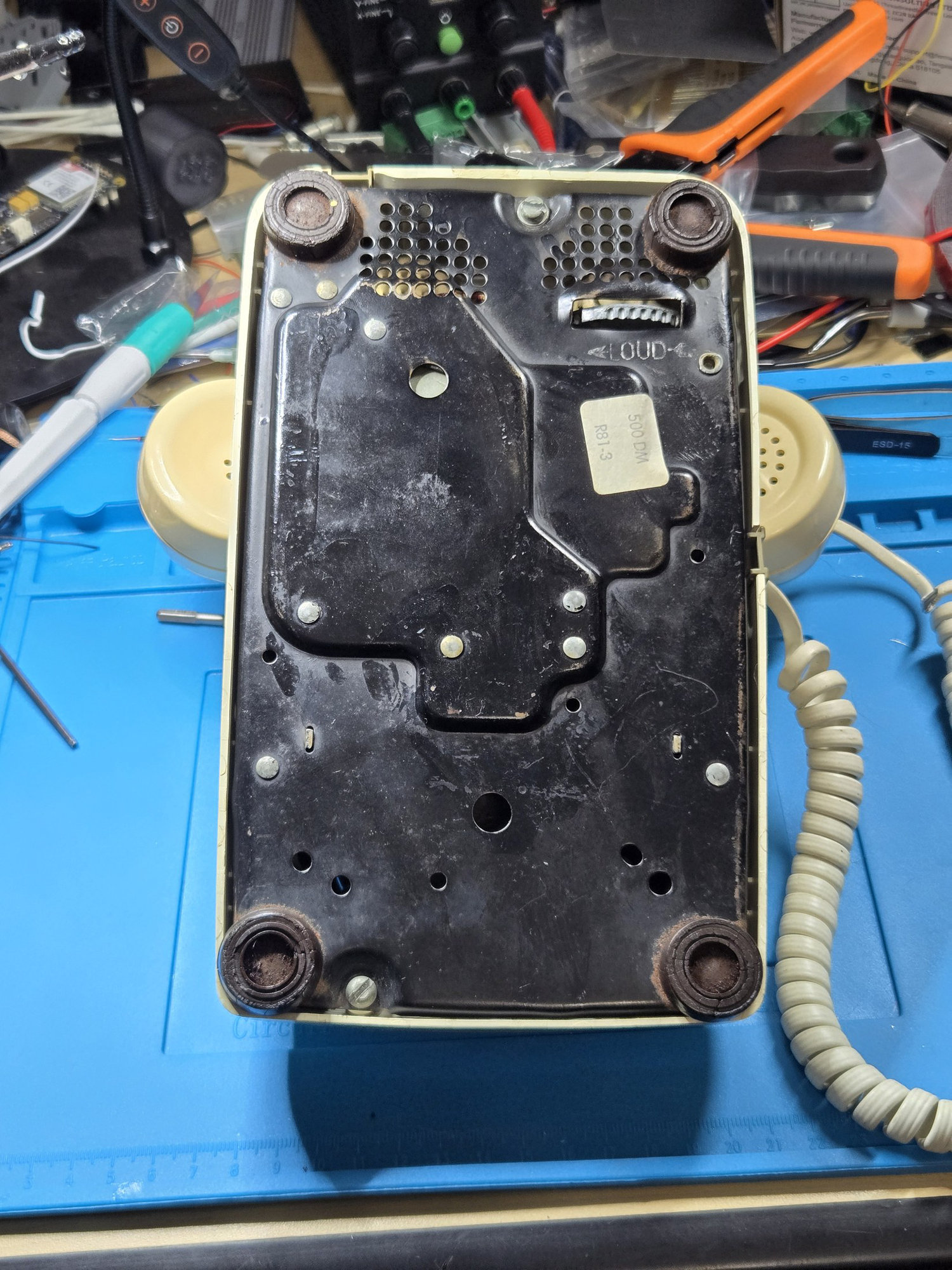 The two housing screws on the underside of the telephone
