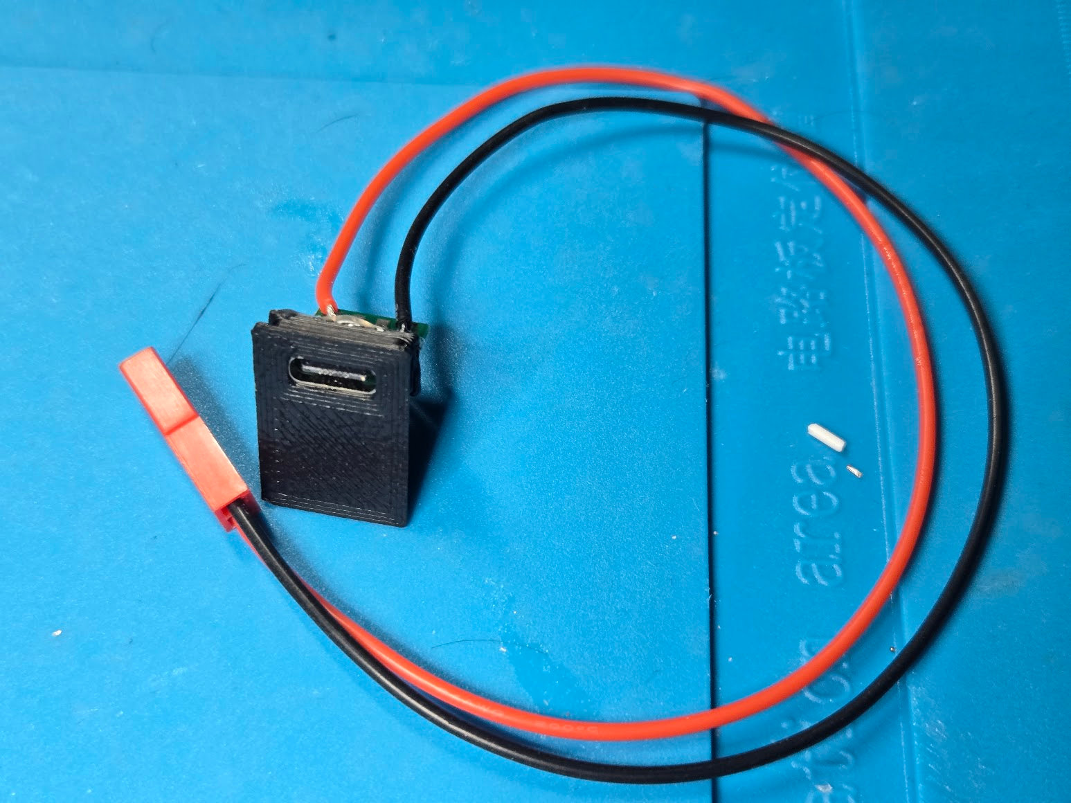 Rect R3 insert assembled around a USB-C breakout with red and black power wires